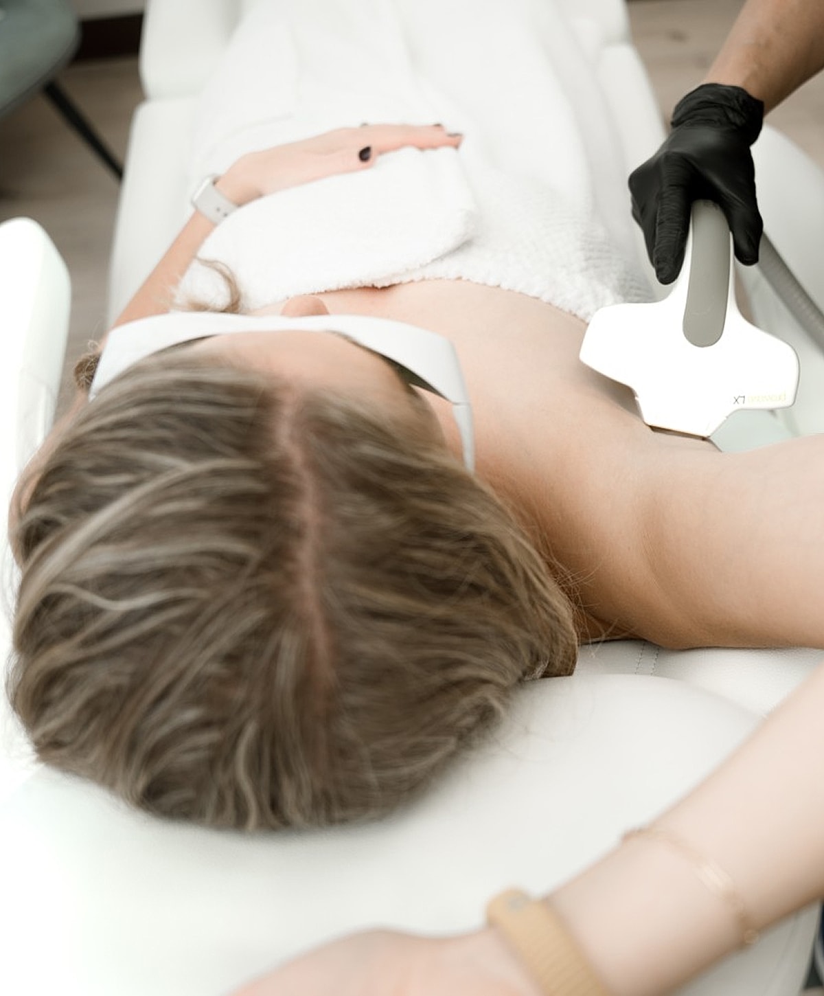 Laser therapy treatment session on patient’s underarm.