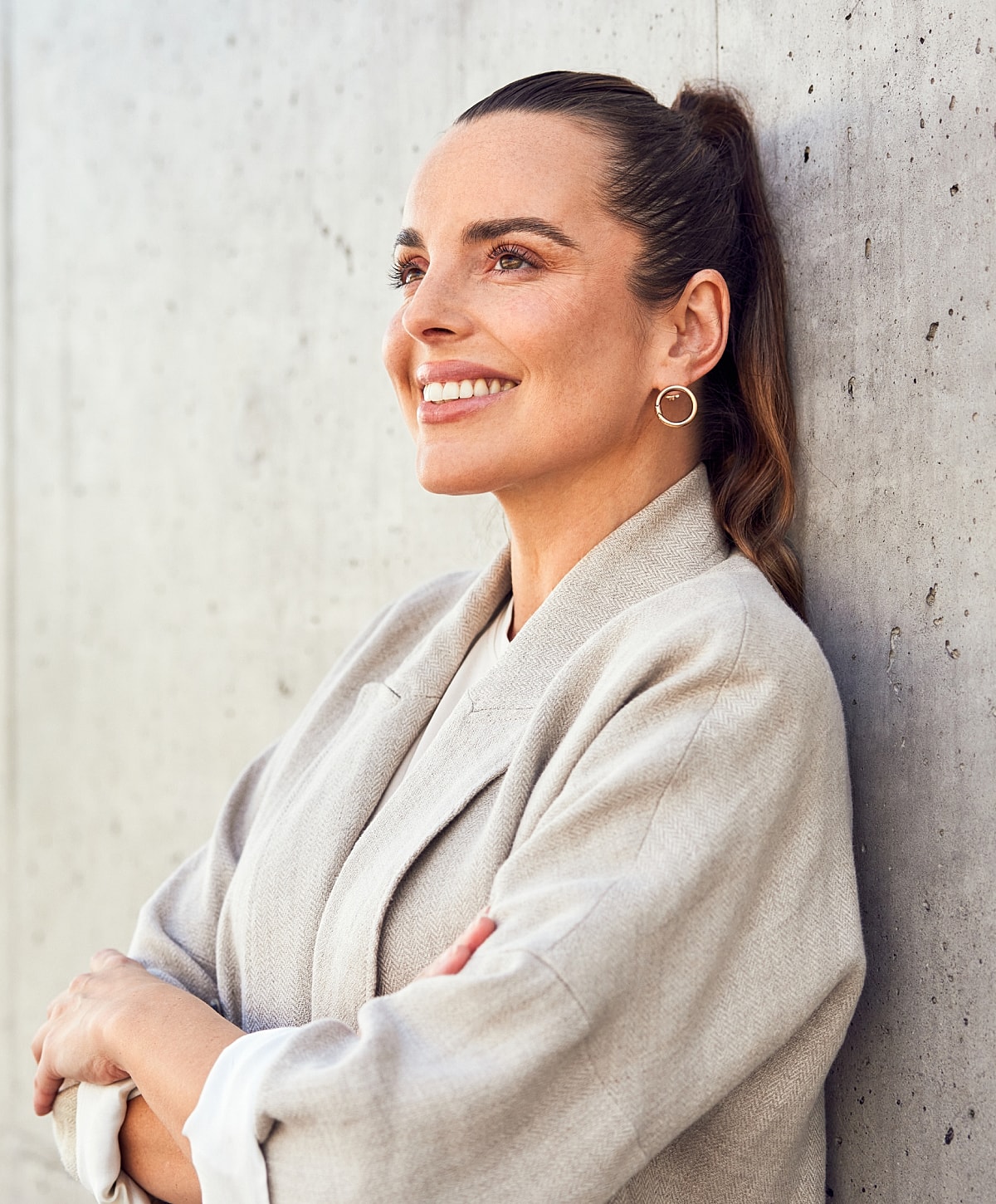 Smiling woman with elegant pose and soft lighting.